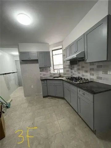 a kitchen with stainless steel appliances granite countertop a sink stove and cabinets