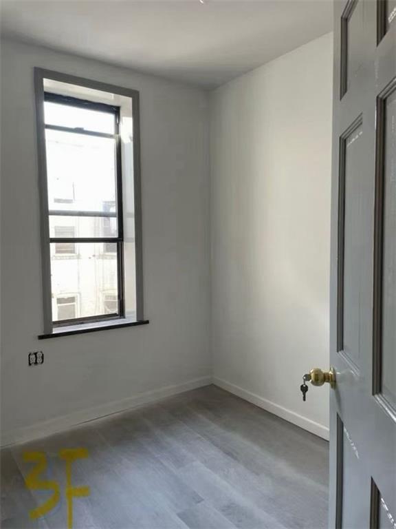 658 46th Street Brooklyn, NY 11220 - Photo 8 of 9 an empty room with a window