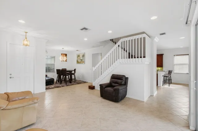 a kitchen with stainless steel appliances kitchen island granite countertop a refrigerator and a stove top oven