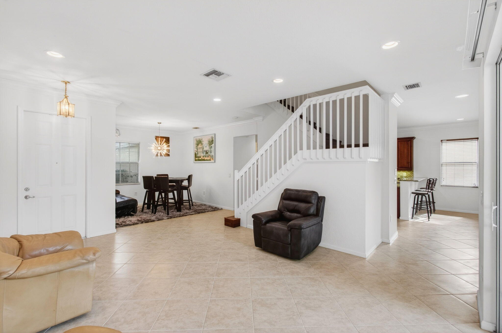 7533 Topiary Avenue Boynton Beach, FL 33437 - Photo 11 of 90 a living room with furniture and a dining table with projector