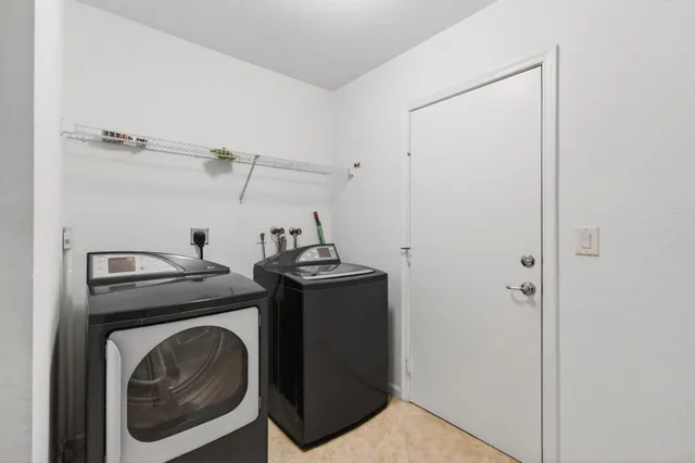 an empty room with wooden floor ceiling fan and windows