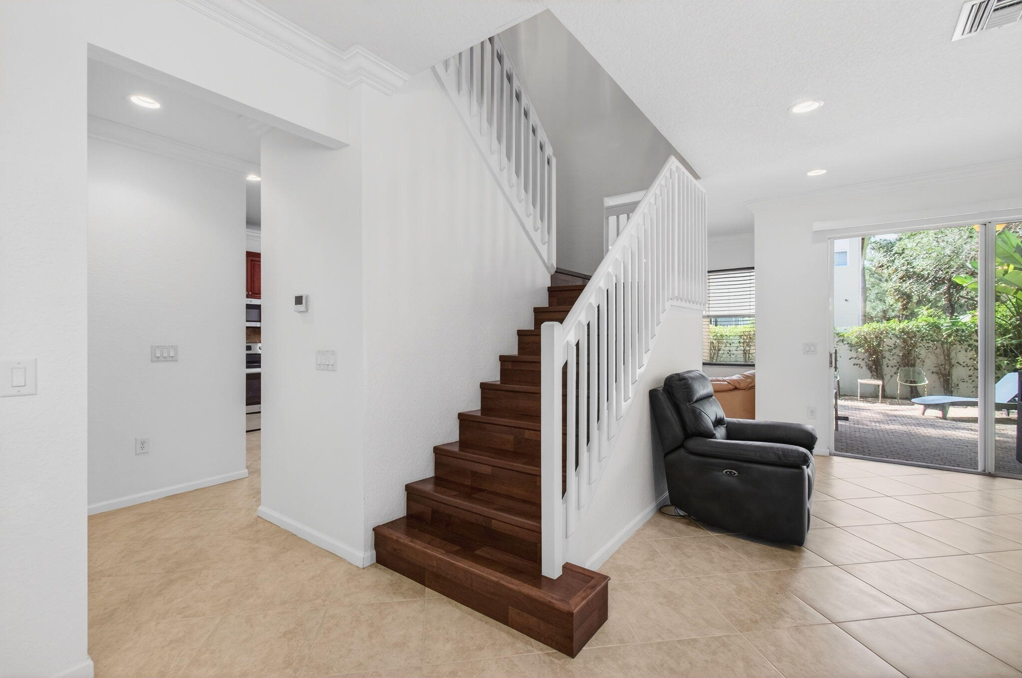 7533 Topiary Avenue Boynton Beach, FL 33437 - Photo 37 of 90 a view of a livingroom with entryway stairs and windows