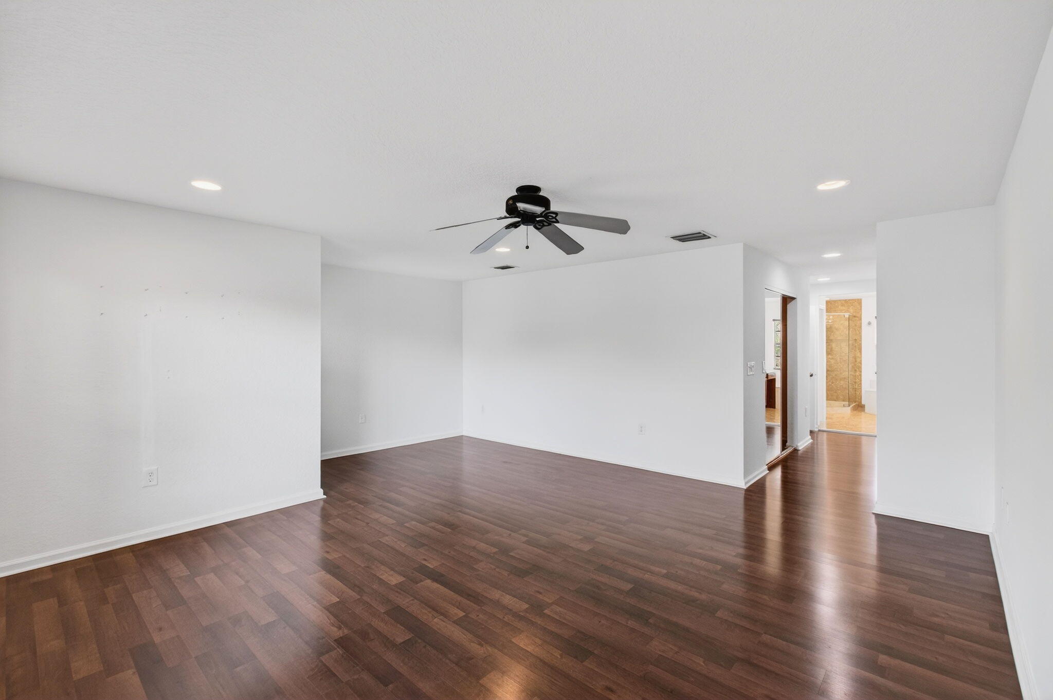 7533 Topiary Avenue Boynton Beach, FL 33437 - Photo 43 of 90 a view of a room with wooden floor and ceiling fan