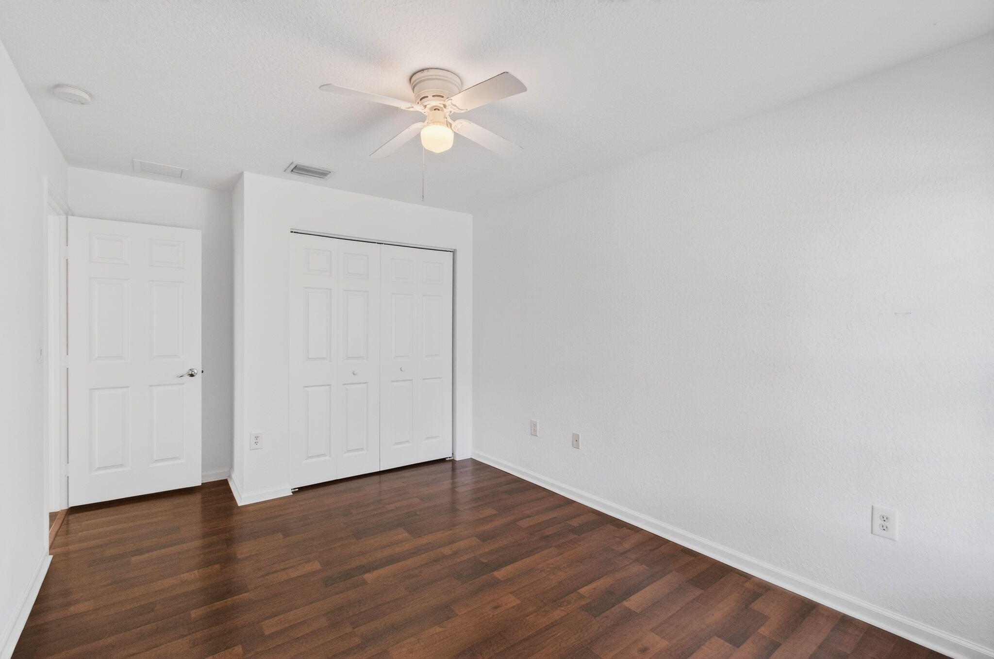 7533 Topiary Avenue Boynton Beach, FL 33437 - Photo 51 of 90 a view of an empty room with wooden floor