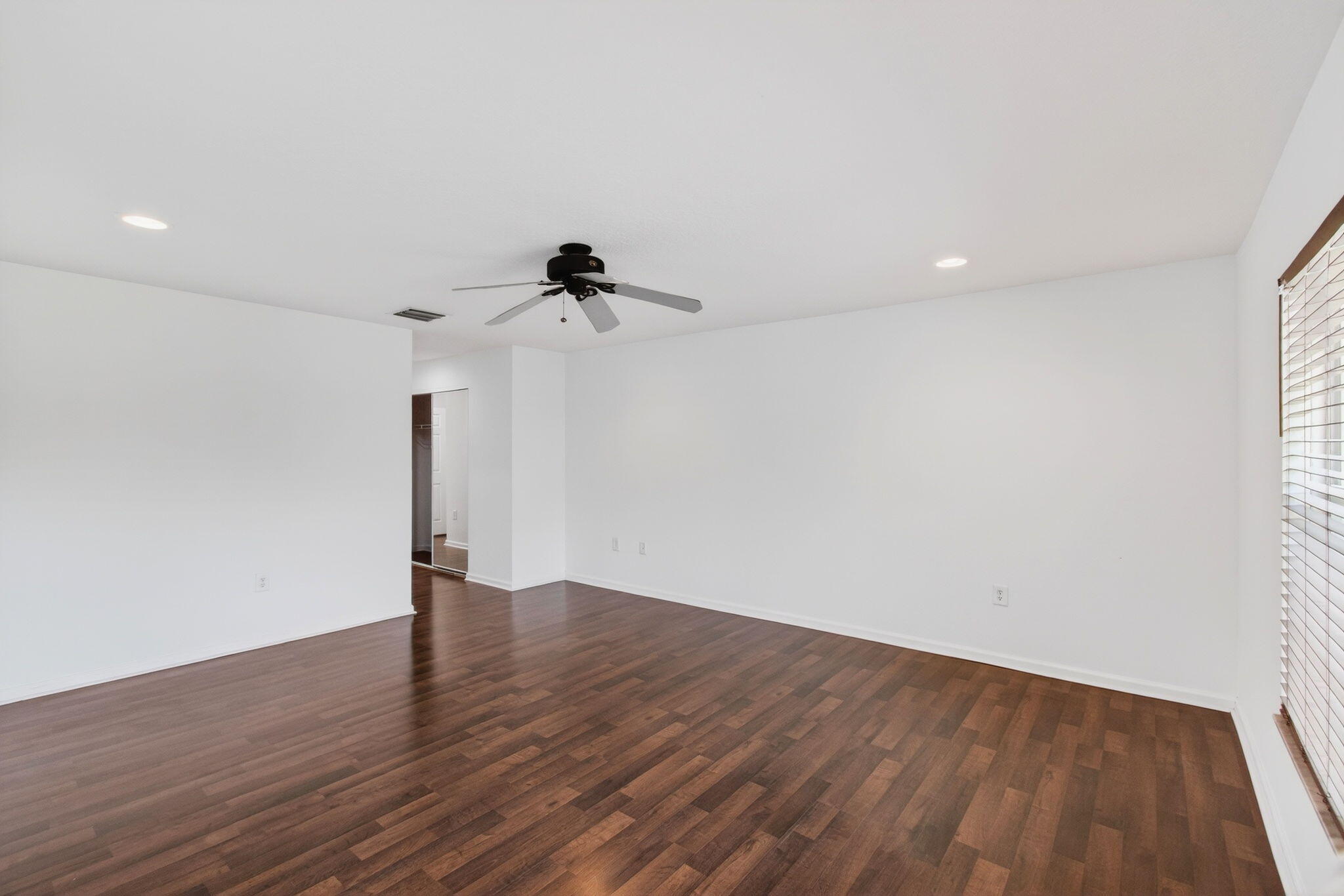 7533 Topiary Avenue Boynton Beach, FL 33437 - Photo 57 of 90 a view of an empty room with wooden floor