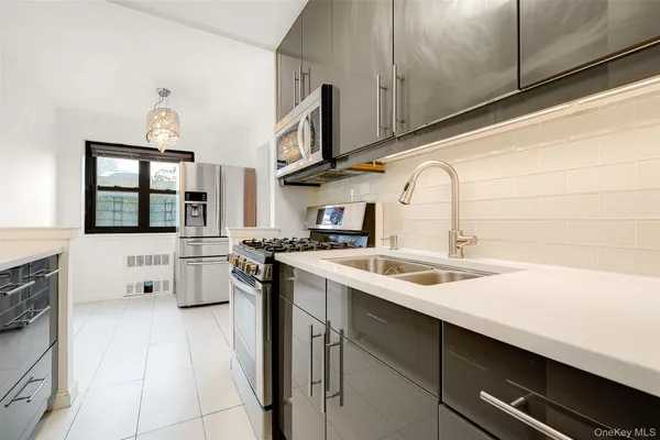 a kitchen with a sink cabinets and appliances
