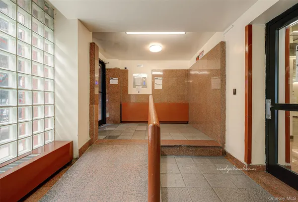 a view of a hallway with a furniture and entryway
