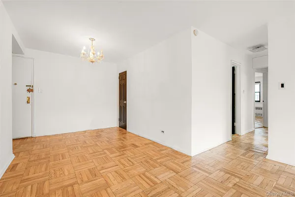 a view of an empty room with a chandelier