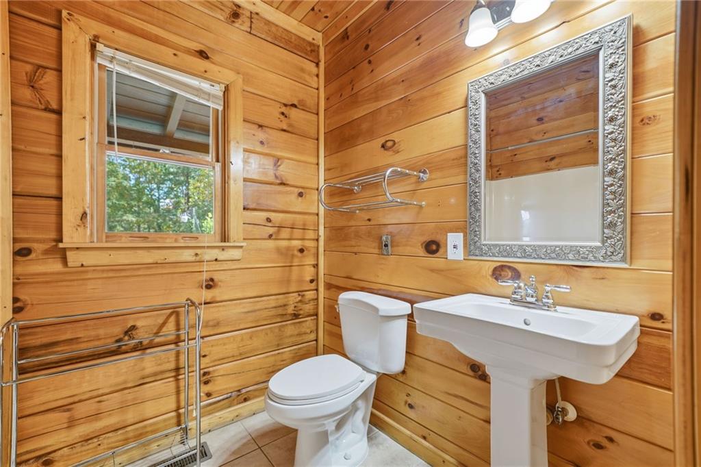 1384 Crystal Lane Northeast Ranger, GA 30734 - Photo 21 of 57 a bathroom with a sink mirror toilet and next to a window