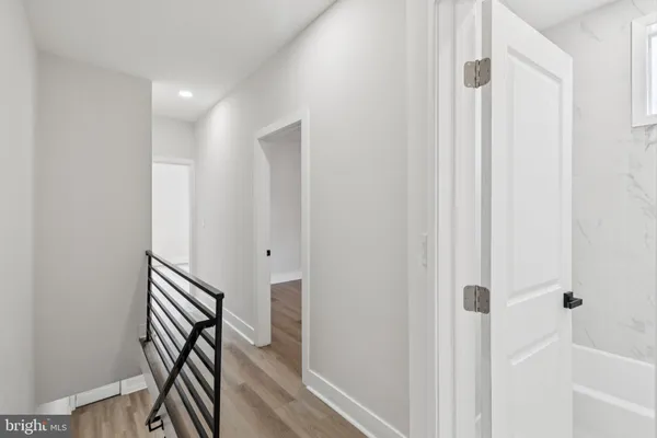 a view of a hallway with wooden floor