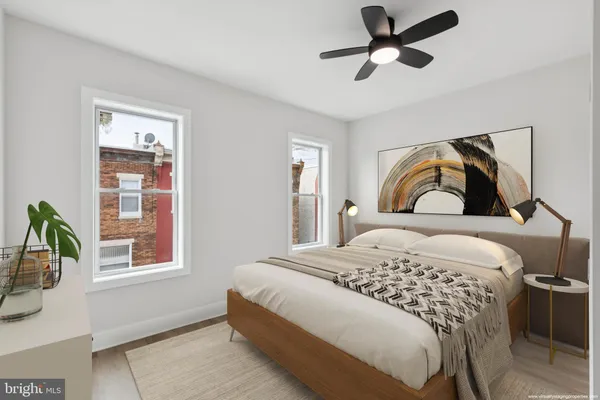 a bedroom with a bed and a painting on the wall