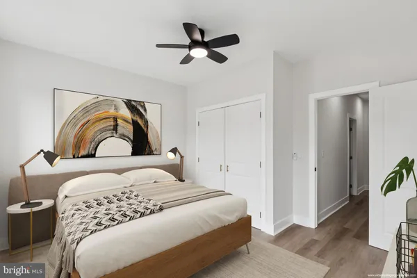 a bedroom with a bed and a potted plant