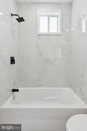 a bathroom with a bathtub and a toilet