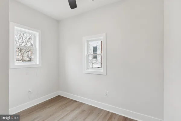 a view of a small space with wooden floor and a window