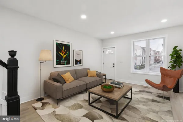 a living room with furniture and a potted plant