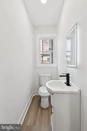 a bathroom with a toilet a sink and a window