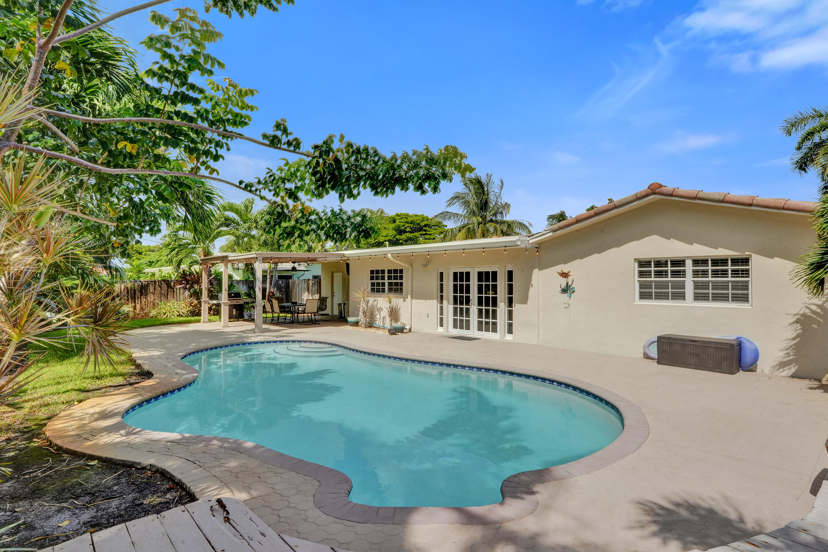 1440 Southeast 4th Court Deerfield Beach, FL 33441 - Photo 20 of 25 front view of a house with a patio