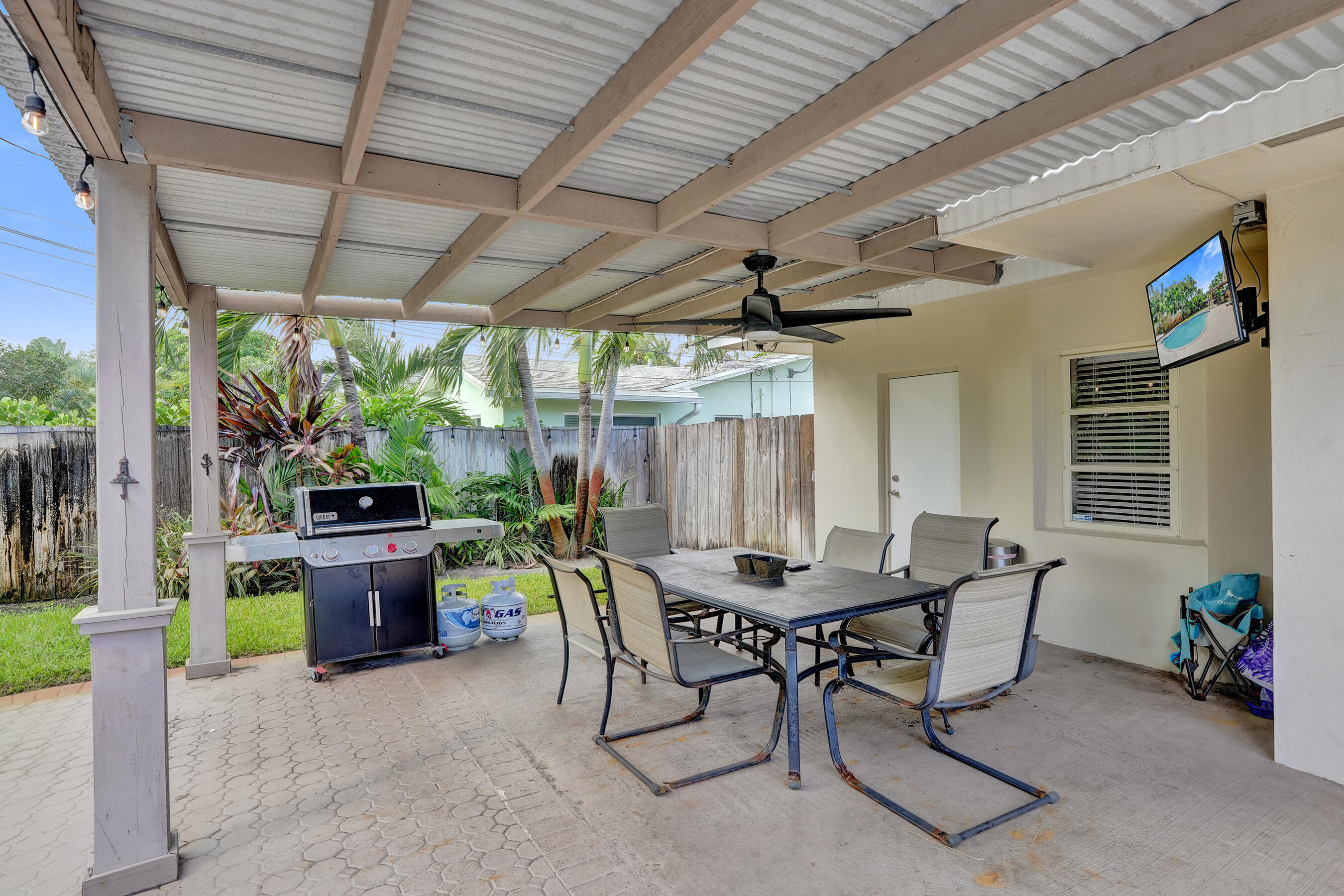 1440 Southeast 4th Court Deerfield Beach, FL 33441 - Photo 23 of 25 a view of a patio with a table and chairs and a barbeque