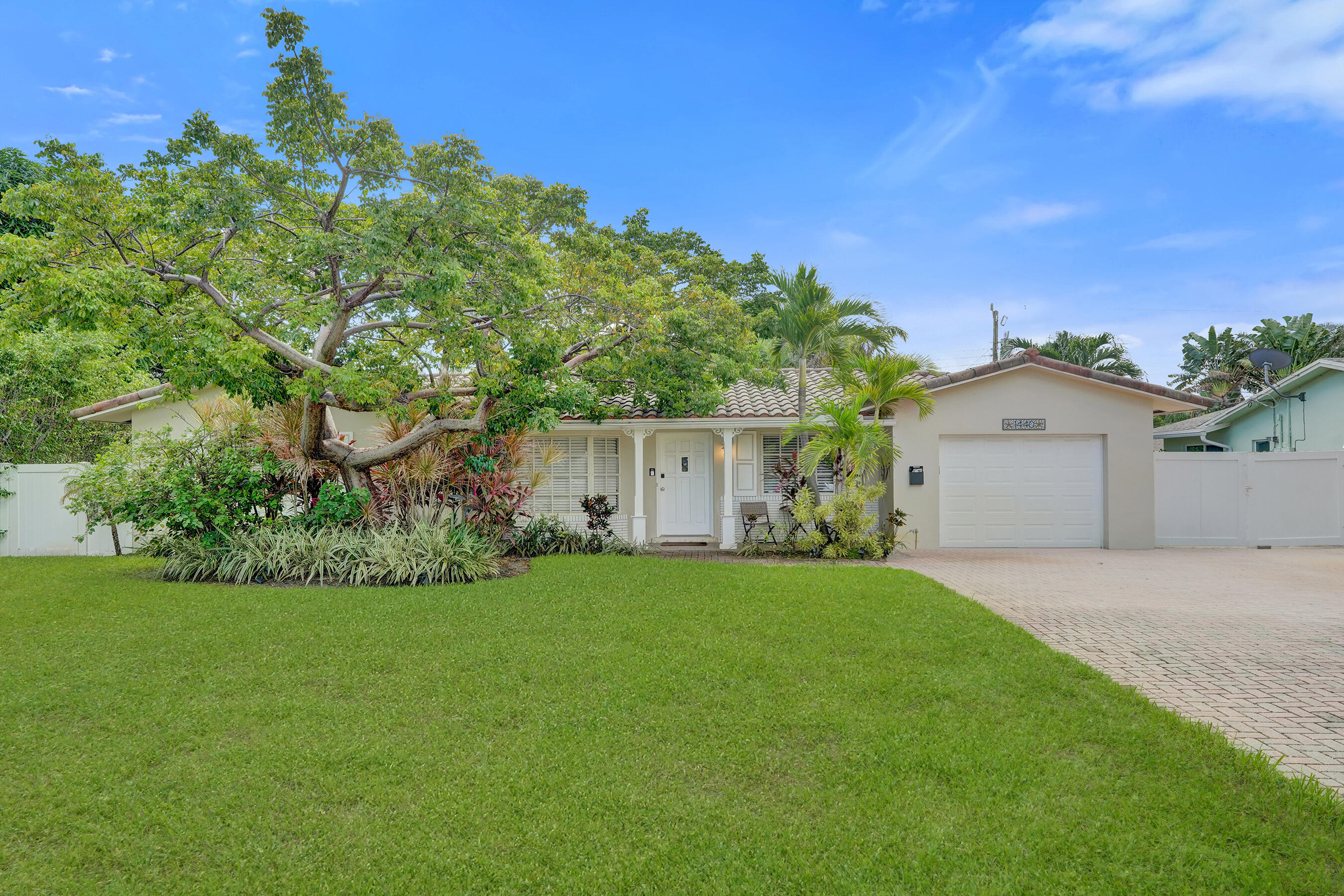 1440 Southeast 4th Court Deerfield Beach, FL 33441 - Photo 25 of 25 a front view of a house with a yard and garage
