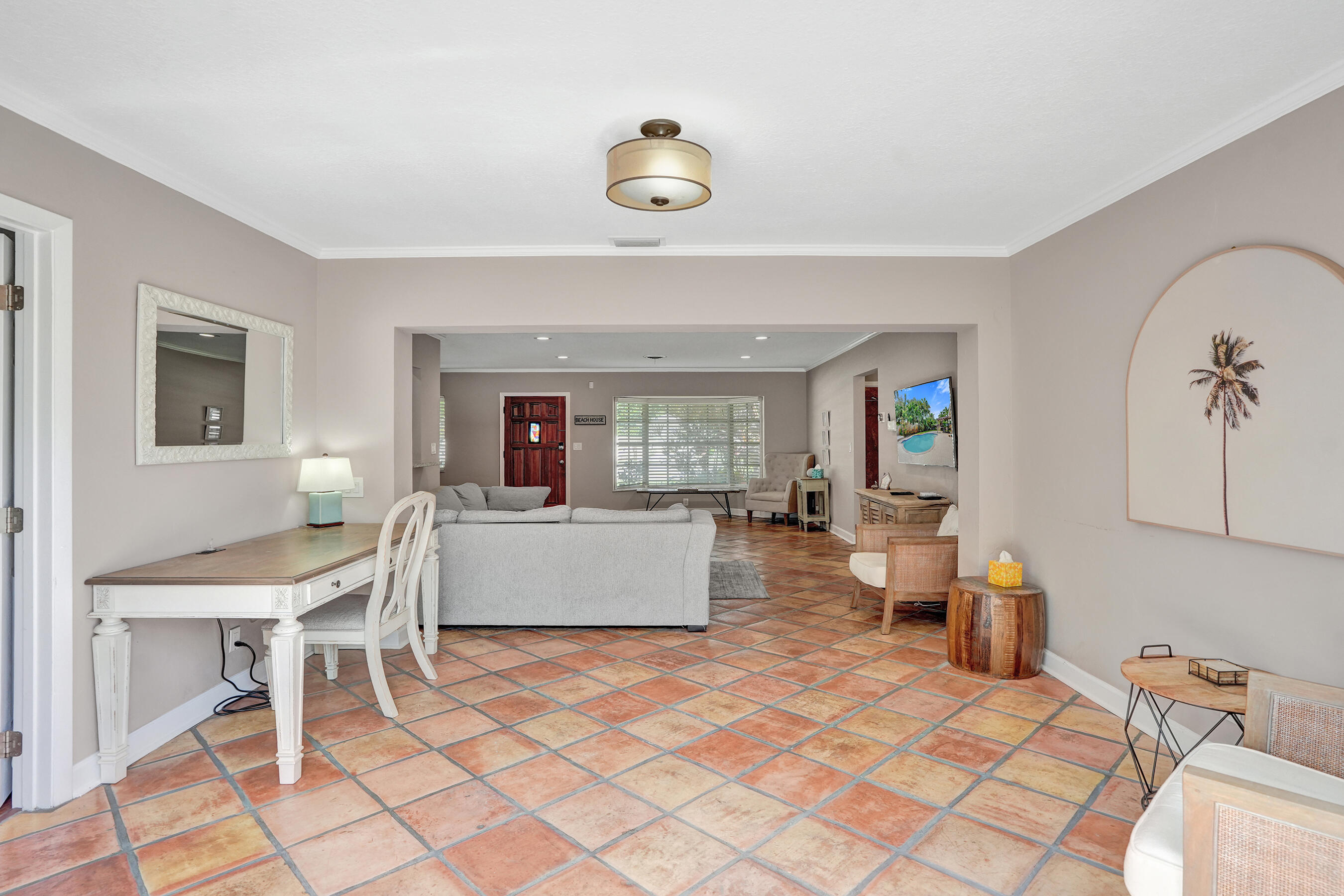 1440 Southeast 4th Court Deerfield Beach, FL 33441 - Photo 6 of 25 a living room with furniture and a chandelier