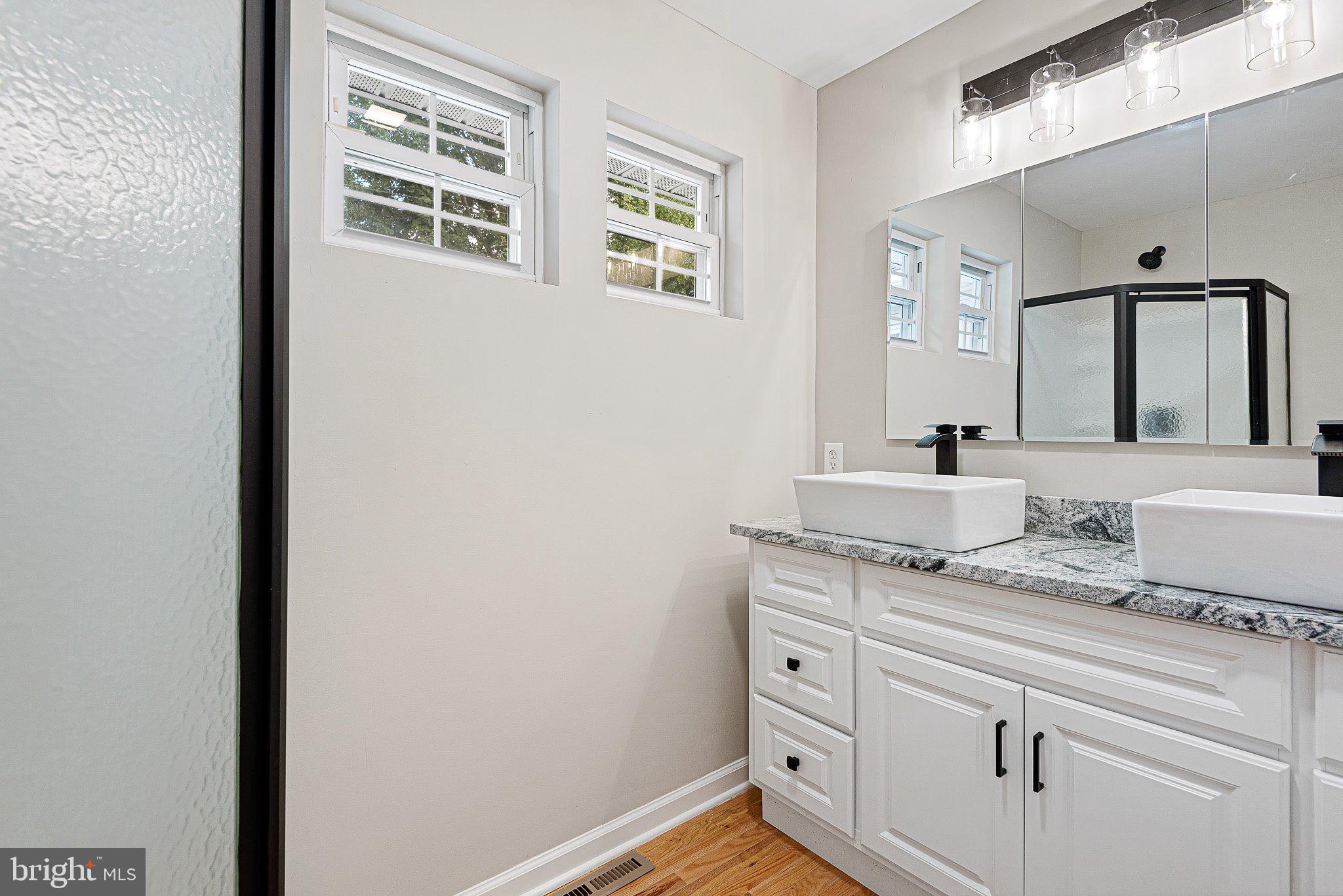 1010 Stinsford Road Newark, DE 19713 - Photo 13 of 30 a bathroom with a granite countertop sink and a mirror