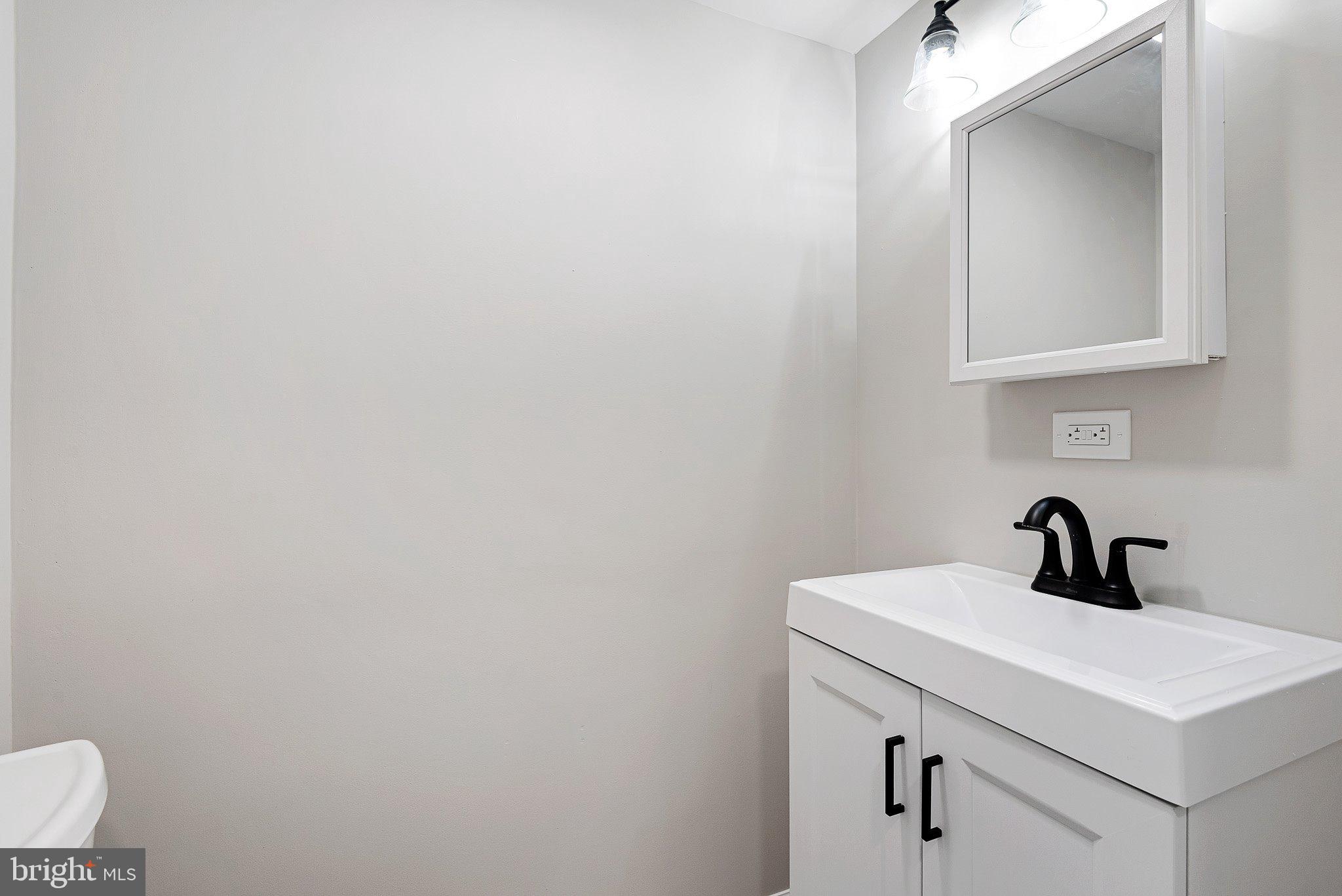 1010 Stinsford Road Newark, DE 19713 - Photo 21 of 30 a bathroom with a sink a mirror and vanity