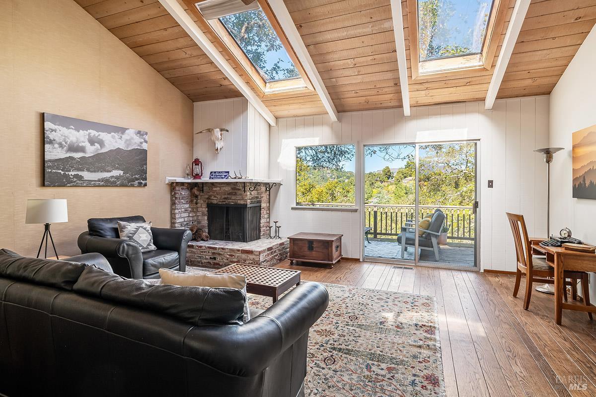 a living room with furniture a large window and a fireplace