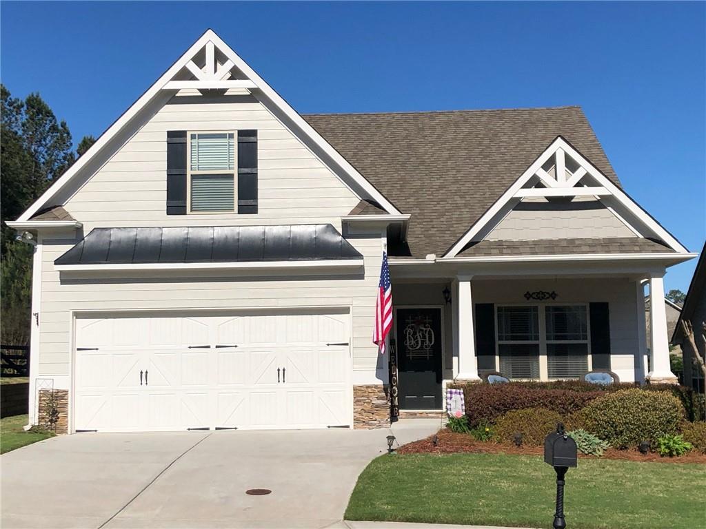 Front View of House with double drive-in garage and front porch to enjoy the morning sun and afternoon shade.