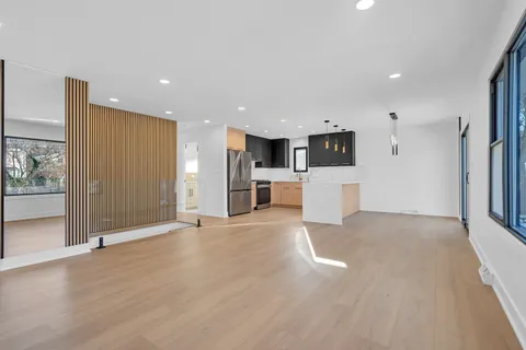 a view of a kitchen with a refrigerator and a stove top oven