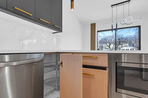 a kitchen with stainless steel appliances granite countertop a refrigerator and a microwave
