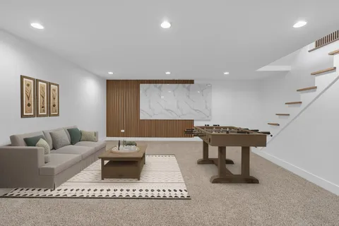 a bedroom with a bed a couch and a flat screen tv