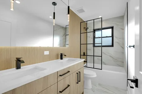 a bathroom with a sink a toilet and a mirror