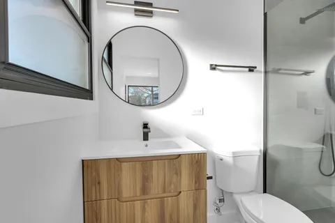 a bathroom with a toilet a sink and mirror