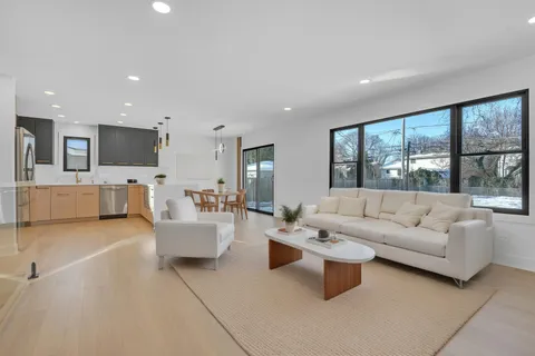 a living room with fireplace furniture and a flat screen tv