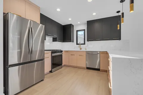 a kitchen with a refrigerator sink and stainless steel appliances