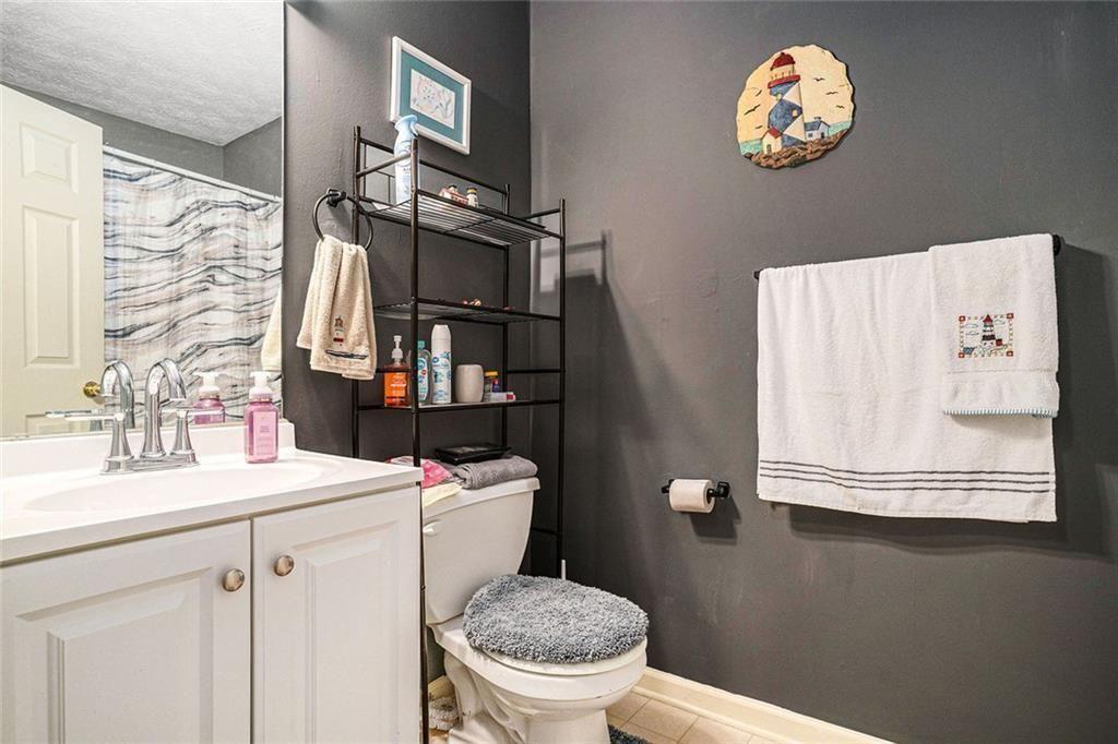 45 Saratoga Way Covington, GA 30016 - Photo 14 of 29 a bathroom with a sink a toilet and a mirror
