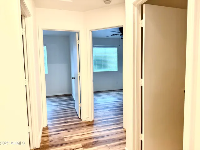 a view of a hallway with wooden floor
