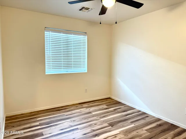 a view of a room with a ceiling fan and a window