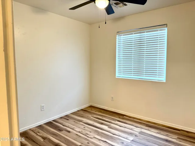 a view of a room with a window and ceiling fan