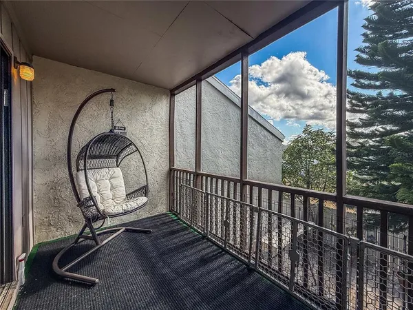 a view of a balcony with a tree