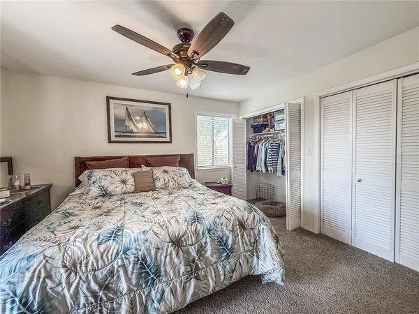 a bathroom with a granite countertop toilet sink and mirror