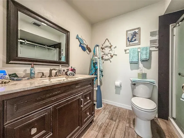 a bathroom with a toilet and a shower