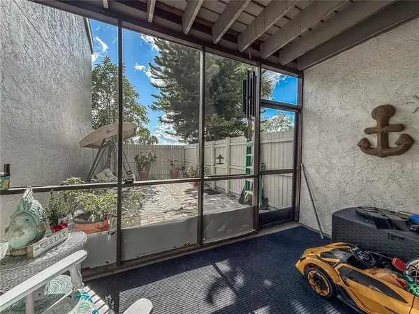 a backyard with a table and chairs and potted plants