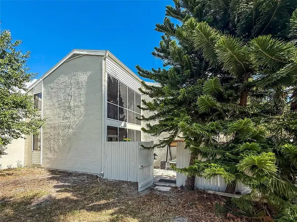 a view of a house with a tree in the background