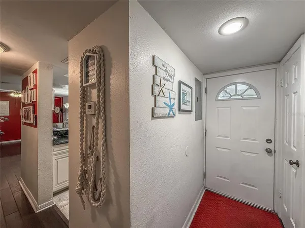 a hallway with cabinets and wooden floor
