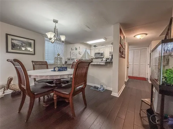 a view of a dining room with furniture and chandelier