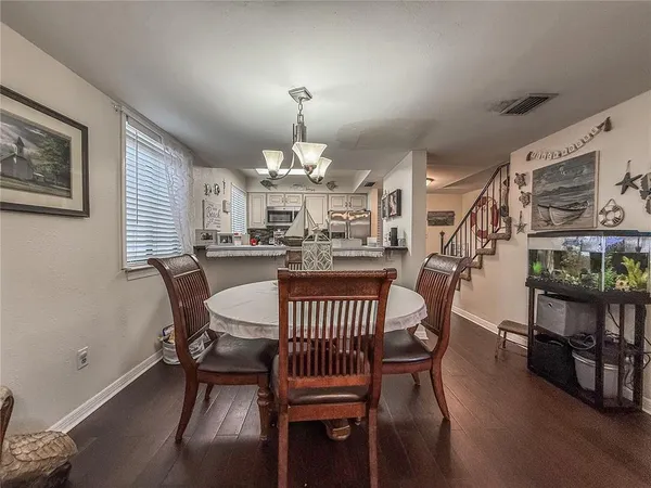 a kitchen with stainless steel appliances granite countertop a sink wooden cabinets and a stove