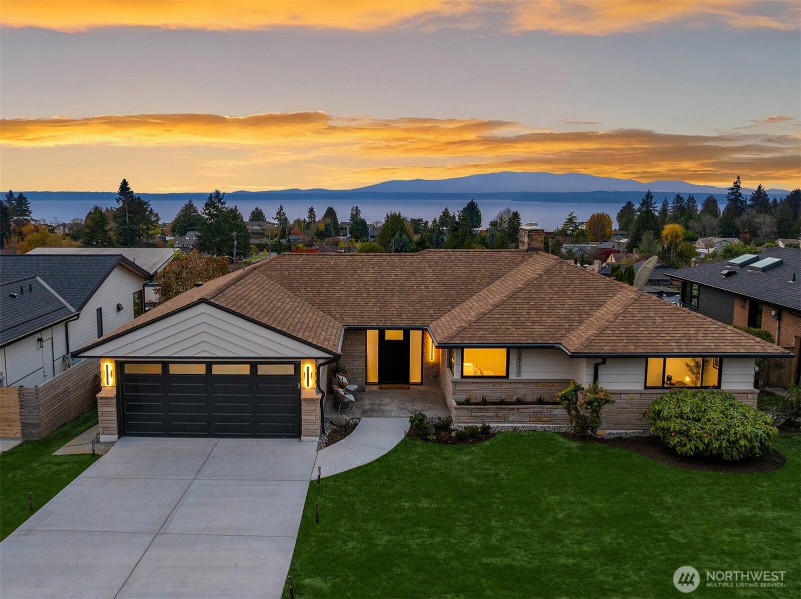 a view of house with garden and ocean view