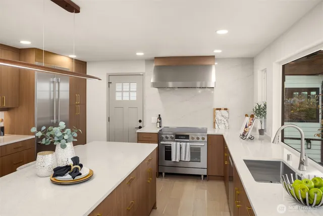 a kitchen with stainless steel appliances kitchen island granite countertop a sink and cabinets