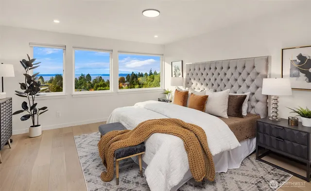 a bedroom with bed and a large window